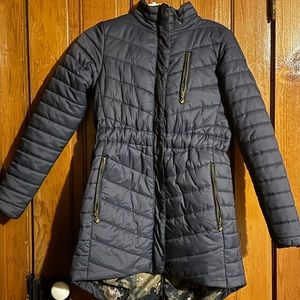 Aubrion mid length, water proof riding coat with fur hood and zipper in back.